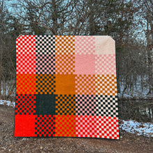 Load image into Gallery viewer, Checkered quilt with orange, black, and pink pattern on a gravel path with trees in the background. Norma Jean bundle available at globalfibershop.com.
