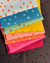 Load image into Gallery viewer, Rainbow set of colorful fabric swatches with star patterns on a black background. Starry available at globalfibershop.com.