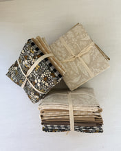 Load image into Gallery viewer, Stack of folded fabric swatches with ribbons on a white background