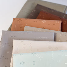 Load image into Gallery viewer, Deco Stitch is the perfect blender for stitch lovers. These low-volume prints will complement your more bold prints without overpowering the project. <br>They also add a beautiful, interesting but subtle texture as a stand-alone fabric. New colors for 2024 available at globalfibershop.com.