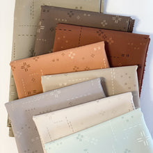 Load image into Gallery viewer, Deco Stitch is the perfect blender for stitch lovers. These low-volume prints will complement your more bold prints without overpowering the project. <br>They also add a beautiful, interesting but subtle texture as a stand-alone fabric. New colors for 2024 available at globalfibershop.com.