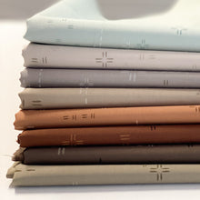 Load image into Gallery viewer, Deco Stitch is the perfect blender for stitch lovers. These low-volume prints will complement your more bold prints without overpowering the project. <br>They also add a beautiful, interesting but subtle texture as a stand-alone fabric. New colors for 2024 available at globalfibershop.com.