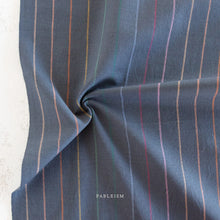Load image into Gallery viewer, Embrace the charm of the rainbow with Fableism Supply Co’s ‘Lucky Loom’ fabric collection—a dazzling fusion of mixed weight wovens inspired by moments of serendipity. This collection’s palette radiates warmth and whimsy, featuring golden yellows, soft pinks, earthy greens, tranquil blues, and rich purples, each reminiscent of the colors in a lucky rainbow. Available at globalfibershop.com.