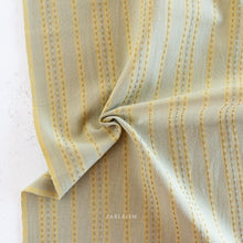 Load image into Gallery viewer, Embrace the charm of the rainbow with Fableism Supply Co’s ‘Lucky Loom’ fabric collection—a dazzling fusion of mixed weight wovens inspired by moments of serendipity. This collection’s palette radiates warmth and whimsy, featuring golden yellows, soft pinks, earthy greens, tranquil blues, and rich purples, each reminiscent of the colors in a lucky rainbow. Available at globalfibershop.com.