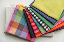 Load image into Gallery viewer, Stack of colorful fabric swatches on a white background. Picnic Wovens by Suzy Quilts for Art Gallery Fabrics, available at globalfibershop.com.