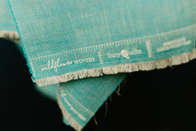 Load image into Gallery viewer, Wildflower Wovens embodies a handmade charm reminiscent of stumbling upon a wild, untamed floral marvel in the heart of nature. Available from globalfibershop.com.