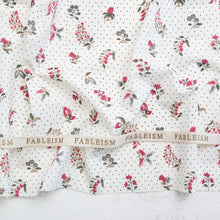 Load image into Gallery viewer, Floral fabric with a ribbon displaying 'Fableism' on a textured surface