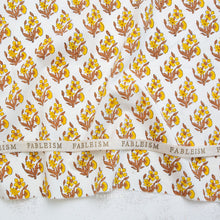 Load image into Gallery viewer, Yellow and gold Floral patterned fabric with 'Fableism' branding on a white background. Indian Block Prints available at globalfibershop.com.