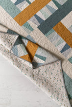 Load image into Gallery viewer, Garland quilt pattern by Suzy Quilts in Winter Walk colorway of light blue, teal and gold. Quilt kits available at globalfibershop.com.