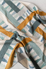 Load image into Gallery viewer, Garland quilt pattern by Suzy Quilts in Winter Walk colorway of light blue, teal and gold. Quilt kits available at globalfibershop.com.