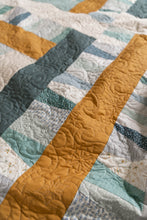 Load image into Gallery viewer, Garland quilt pattern by Suzy Quilts in Winter Walk colorway of light blue, teal and gold. Quilt kits available at globalfibershop.com.