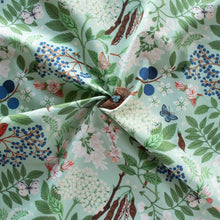 Load image into Gallery viewer, Gander the trees that produce the most beautiful of blooms, attracting lovely birds, butterflies, and bees to drink nectar, play in pollen, and seek shelter in their branches. Flowering trees features 13 prints on undyed organic cotton poplin. Sold at globalfibershop.com

