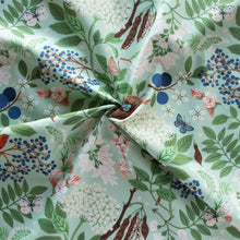 Load image into Gallery viewer, Gander the trees that produce the most beautiful of blooms, attracting lovely birds, butterflies, and bees to drink nectar, play in pollen, and seek shelter in their branches. Flowering trees features 13 prints on undyed organic cotton poplin. Sold at globalfibershop.com