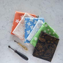 Load image into Gallery viewer, Gander the trees that produce the most beautiful of blooms, attracting lovely birds, butterflies, and bees to drink nectar, play in pollen, and seek shelter in their branches. Flowering trees features 13 prints on undyed organic cotton poplin. Sold at globalfibershop.com