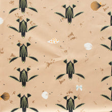Load image into Gallery viewer, Turtles trek past a beach with shells printed on 100% GOT certified organic cotton poplin for Birch Fabrics.
