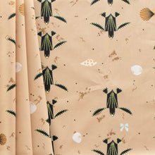 Load image into Gallery viewer, Turtles trek past a beach with shells printed on 100% GOT certified organic cotton poplin for Birch Fabrics.