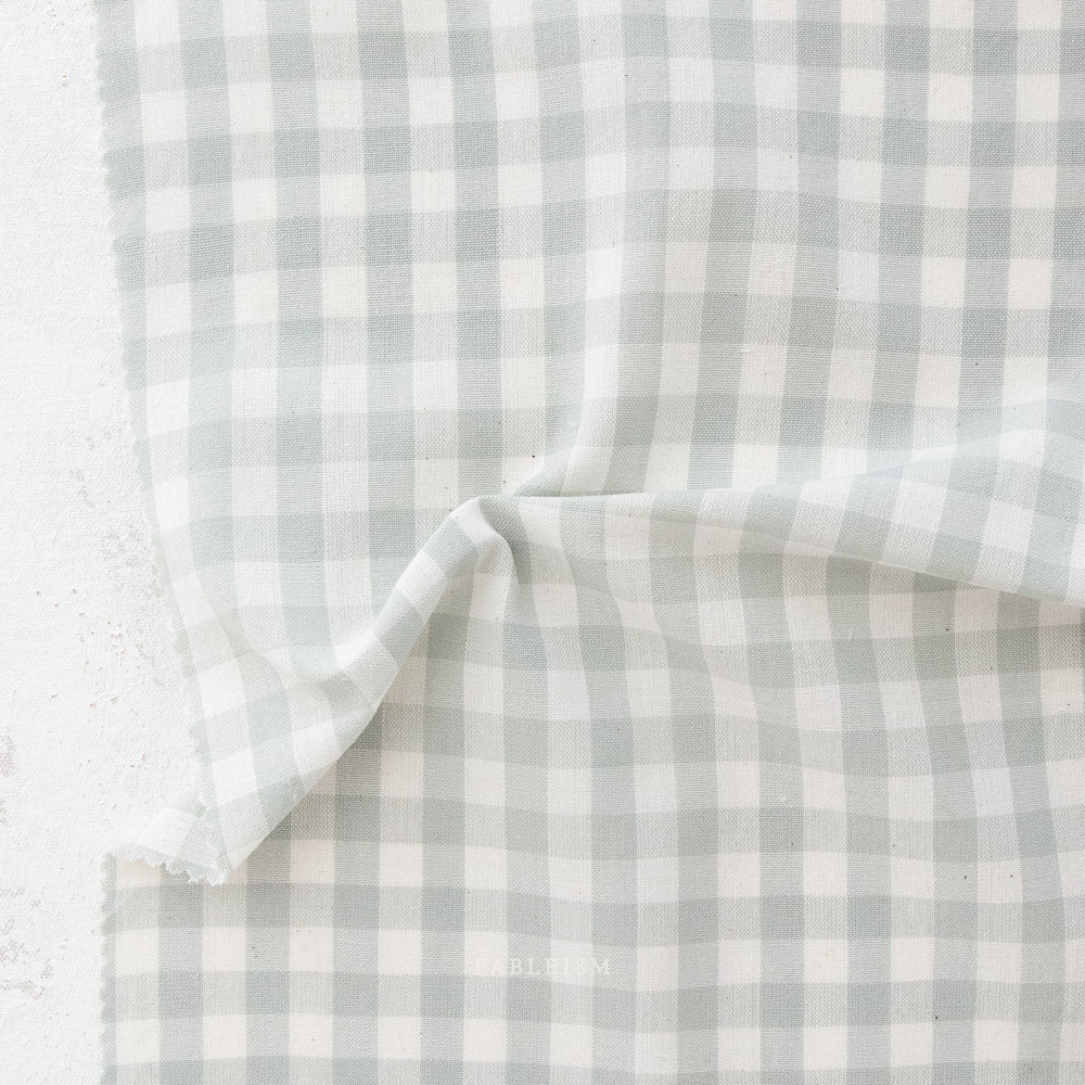 Camp Ginghams collection brings forth a classic woven style in gorgeous colors, reminiscent of retro camp uniforms. Think Moonrise Kingdom meets classic gingham! Camp Gingham is offering two sizes of yarn-dyed cotton gingham 3/8″ and 2.25″. Each size has a multitude of purposes from quilts, to apparel, to table settings! Sold at globalfibershop.com.