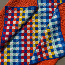 Load image into Gallery viewer, Colorful quilt with a geometric pattern on a textured surface
