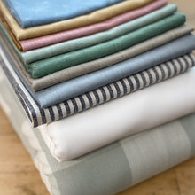Load image into Gallery viewer, Our scrappy Cozy Cottage bundle from The Seasoned Homemaker features 6 fat quarters from Fableism Supply Co. in muted hues on a white background. Sold exclusively at globalfibershop.com.

