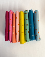 Load image into Gallery viewer, Rainbow set of colorful fabric swatches with star patterns on a white background. Starry available at globalfibershop.com.

