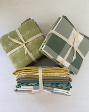 Load image into Gallery viewer, Three folded fabric swatches tied with ribbons on a white background
