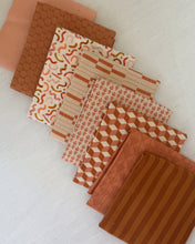 Load image into Gallery viewer, Collection of patterned fabric squares in brown and beige tones on a white background
