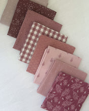 Load image into Gallery viewer, Collection of patterned fabric swatches in shades of red and brown on a light background
