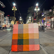 Load image into Gallery viewer, Checkered quilt with orange, black, and pink pattern on a gravel path with trees in the background. Norma Jean bundle available at globalfibershop.com.
