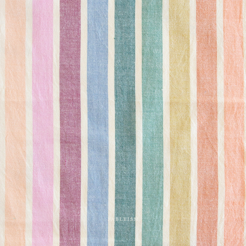 Embrace the charm of the rainbow with Fableism Supply Co’s ‘Lucky Loom’ fabric collection—a dazzling fusion of mixed weight wovens inspired by moments of serendipity. This collection’s palette radiates warmth and whimsy, featuring golden yellows, soft pinks, earthy greens, tranquil blues, and rich purples, each reminiscent of the colors in a lucky rainbow. Available at globalfibershop.com.