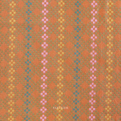 Woven fabric with a geometric design featuring shades of orange, pink, and green. Embrace the charm of the rainbow with Fableism Supply Co’s ‘Lucky Loom’ fabric collection—a dazzling fusion of mixed weight wovens inspired by moments of serendipity. This collection’s palette radiates warmth and whimsy, featuring golden yellows, soft pinks, earthy greens, tranquil blues, and rich purples, each reminiscent of the colors in a lucky rainbow. Available at globalfibershop.com.