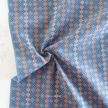 Load image into Gallery viewer, Close-up of blue and orange woven fabric.  Embrace the charm of the rainbow with Fableism Supply Co’s ‘Lucky Loom’ fabric collection—a dazzling fusion of mixed weight wovens inspired by moments of serendipity. This collection’s palette radiates warmth and whimsy, featuring golden yellows, soft pinks, earthy greens, tranquil blues, and rich purples, each reminiscent of the colors in a lucky rainbow. Available at globalfibershop.com.
