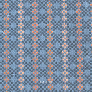Woven fabric with a blue and orange pattern. Blue and orange woven fabric.  Embrace the charm of the rainbow with Fableism Supply Co’s ‘Lucky Loom’ fabric collection—a dazzling fusion of mixed weight wovens inspired by moments of serendipity. This collection’s palette radiates warmth and whimsy, featuring golden yellows, soft pinks, earthy greens, tranquil blues, and rich purples, each reminiscent of the colors in a lucky rainbow. Available at globalfibershop.com.