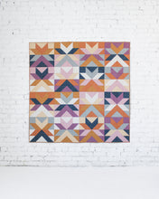 Load image into Gallery viewer, Colorful geometric quilt hanging on a white brick wall
