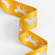 Yellow ribbon with black and white animal pattern on a white background. Bags, totes, key rings - the possibilities are endless! We are now stocking fun and flirty webbing, designed by your favorite Ruby Star Society designers for Stitch Supply Co. Sold at globalfibershop.com.