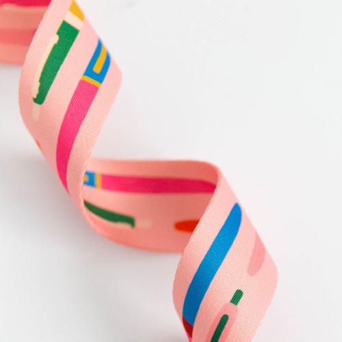 Colorful ribbons with pink, green, and blue patterns on a white background