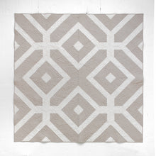 Load image into Gallery viewer, The Villager Quilt design reflects how “villagers” link arms and surround their community members in times of need.  The two-tone Winter White version is available at globalfibershop.com.
