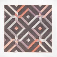 The Duval, scappy bundle features 8 prints from the Duval Collection by Suzy Quilts for Art Gallery Fabrics against an Art Gallery Fabrics Pure Solids background. Villager Quilt Pattern and bundle available at globalfibershop.com.