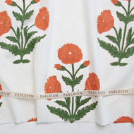 Floral patterned fabric with green leaves and orange flowers, featuring the brand 'Fableism'. Available at globalfibershop.com.