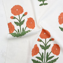 Load image into Gallery viewer, Block printed fabric with orange floral patterns on a white background. Available at globalfibershop.com.
