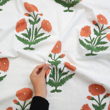 Load image into Gallery viewer, Block printed fabric with orange floral patterns on a white background. Available at globalfibershop.com.
