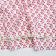 Fableism fabric with pink floral pattern on a white background. Indian Block Prints available at globalfibershop.com.