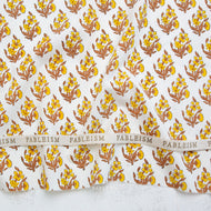 Yellow and gold Floral patterned fabric with 'Fableism' branding on a white background. Indian Block Prints available at globalfibershop.com.