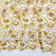 Gold floral pattern on white fabric with 'Fableism' branding. Indian Block Prints available at globalfibershop.com.