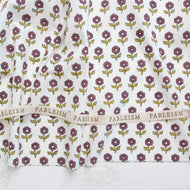 Floral patterned fabric with 'Fableism' branding on a white background. Indian Block Prints available at globalfibershop.com.