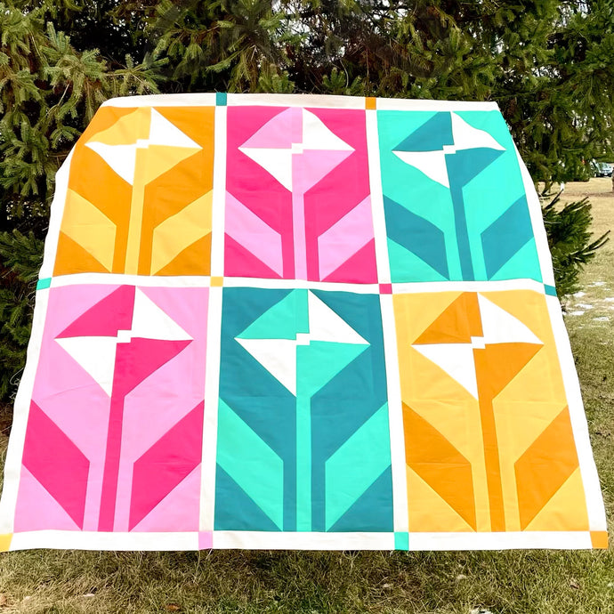 This limited color version of the Wildflower Quilt Pattern from Suzy Quilts features 6 Art Gallery Fabrics PURE solids. We took our color inspiration from Art Gallery Fabrics’ Abode Collection, which makes perfect color-coordinated backings. Availabe at globalfibershop.com.
