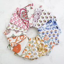 Load image into Gallery viewer, Set of colorful fabric swatches arranged in a circular pattern on a textured surface. Indian Block Prints from Fableism available at globalfibershop.com
