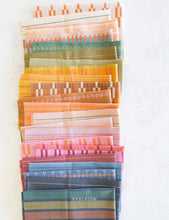 Load image into Gallery viewer, Embrace the charm of the rainbow with Fableism Supply Co’s ‘Lucky Loom’ fabric collection—a dazzling fusion of mixed weight wovens inspired by moments of serendipity. This collection’s palette radiates warmth and whimsy, featuring golden yellows, soft pinks, earthy greens, tranquil blues, and rich purples, each reminiscent of the colors in a lucky rainbow. Available at globalfibershop.com.
