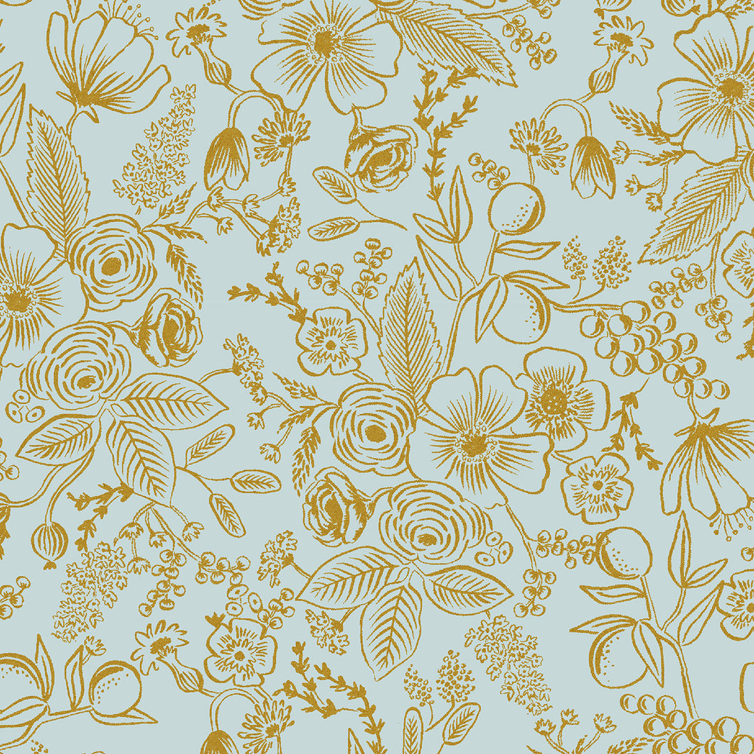Gold floral pattern on a light blue background. Holiday Classics by Rifle Paper Company are a staple for holiday making. Gorgeous florals in modern color stories. Always fresh, relevant and beautiful! Available at globalfibershop.com.