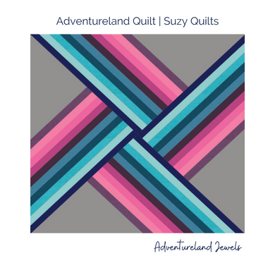 Pink, purple and blue strips on grey background in the Adventureland Quilt Pattern. 