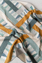 Load image into Gallery viewer, Garland quilt pattern by Suzy Quilts in Winter Walk colorway of light blue, teal and gold. Quilt kits available at globalfibershop.com.
